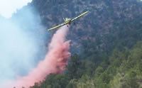 Photo of a Single Engine Airtanker dropping retardant
