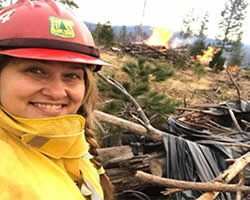 female wildland firefighter wearing helment