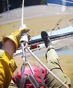 firefighter rappeling out of helicopter