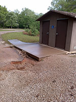 (image) Soil eroded around restroom