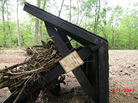 (image)  Bulliten Board covered with debris and up rooted.