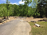 (image) Road covered with debris and eroded bed