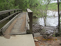 (image) Trail bridge covered with mud.