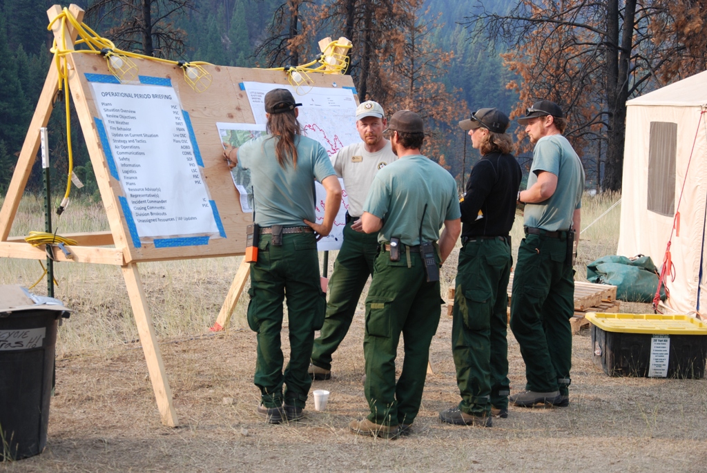 Firefighters gathered for the morning briefing at the incident command post