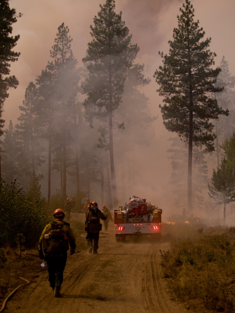 Firefighters hiking into a wildfire