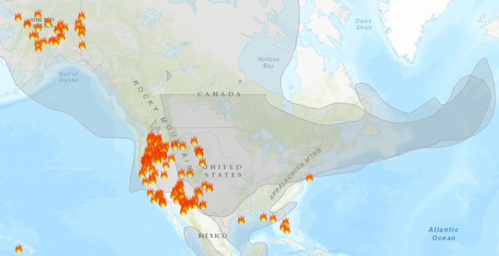 map of US and Canada showing active fire locations and smoke plumes covering most of the continent