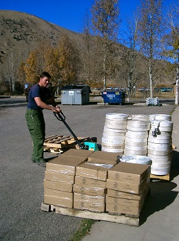 Image of hose and boxes being taken off a pallet